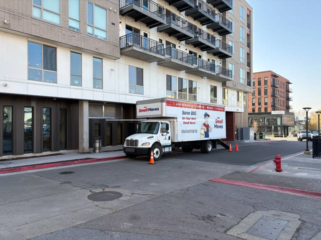Local movers Salt Lake City trusts at downtown apartment building in their box truck