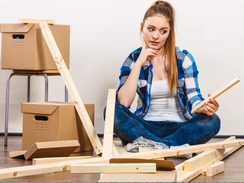 Murray Movers helping confused homeowner trying to reassemble shelving