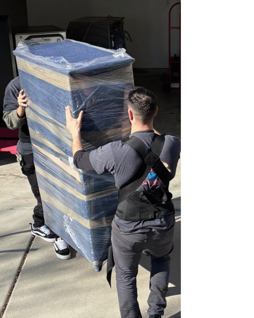 Local Salt Lake City Movers carrying furniture to moving truck.