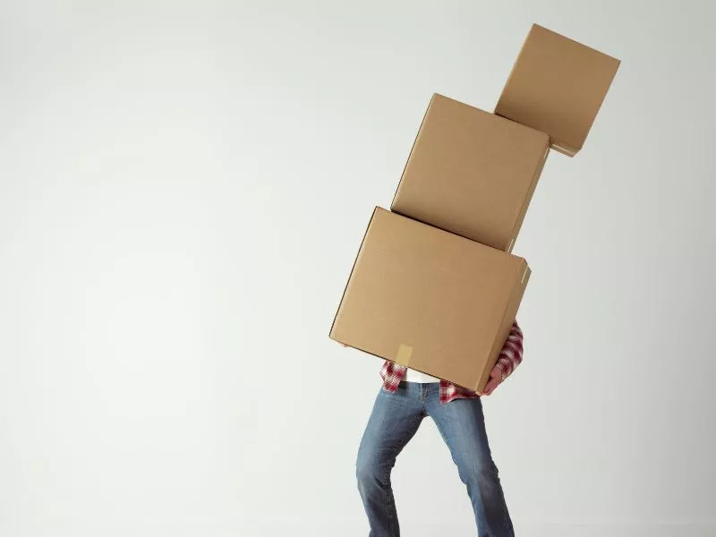 Salt Lake City Resident carrying a tower of packing boxes
